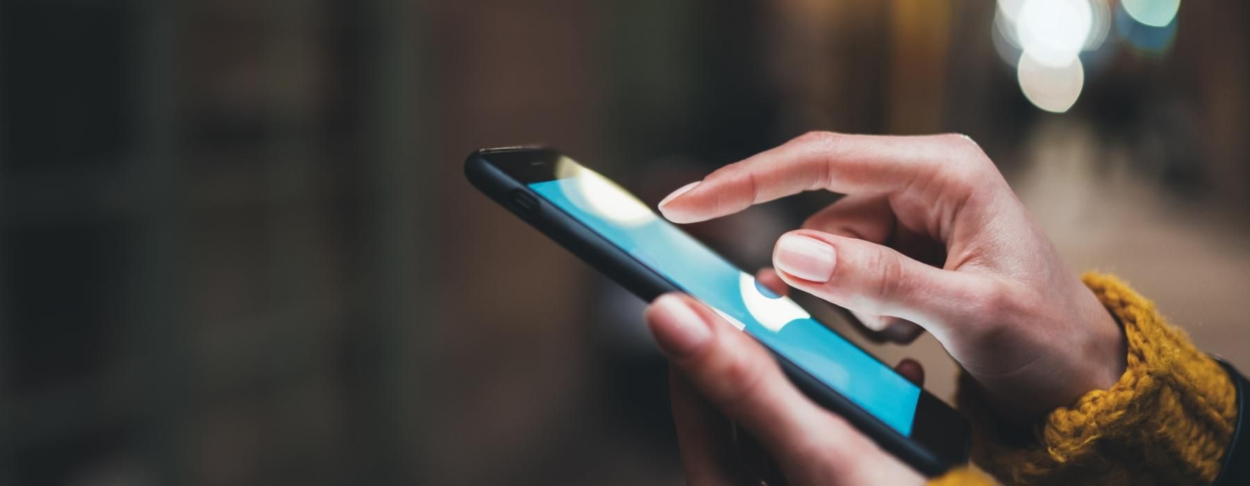 a person holds a cell phone