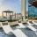 a pool with lounge chairs and umbrellas